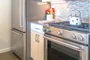 The gourmet kitchen at One Union Square South features Euro-style cabinetry and granite countertops.