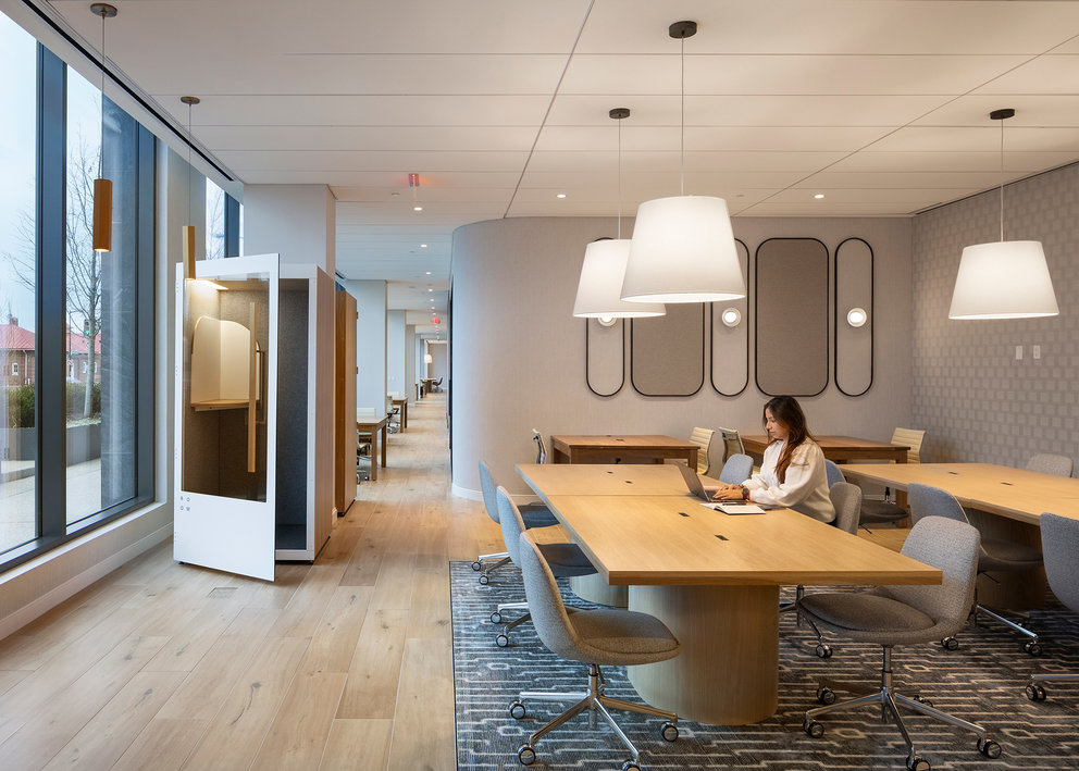 The resident-only co-working lounge includes individual workstations, private offices, and conferencing spaces.