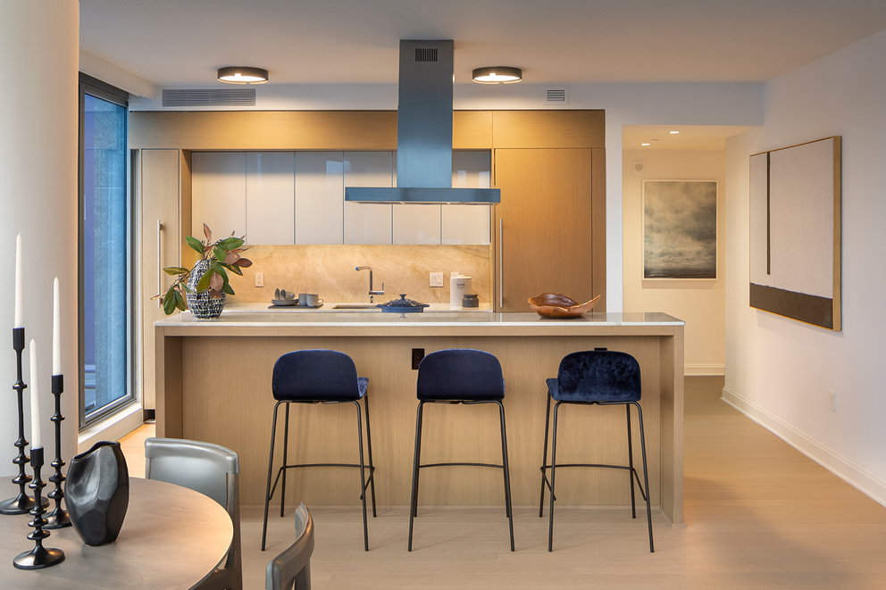 Custom kitchens feature Italian oak cabinetry and natural Brazilian quartzite countertops.