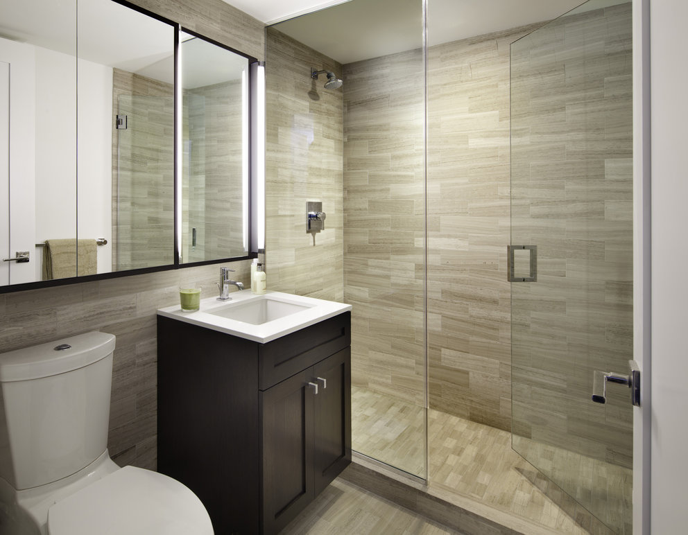 Luxurious bathrooms are clad in marble and include oversize medicine cabinets for easy storage.