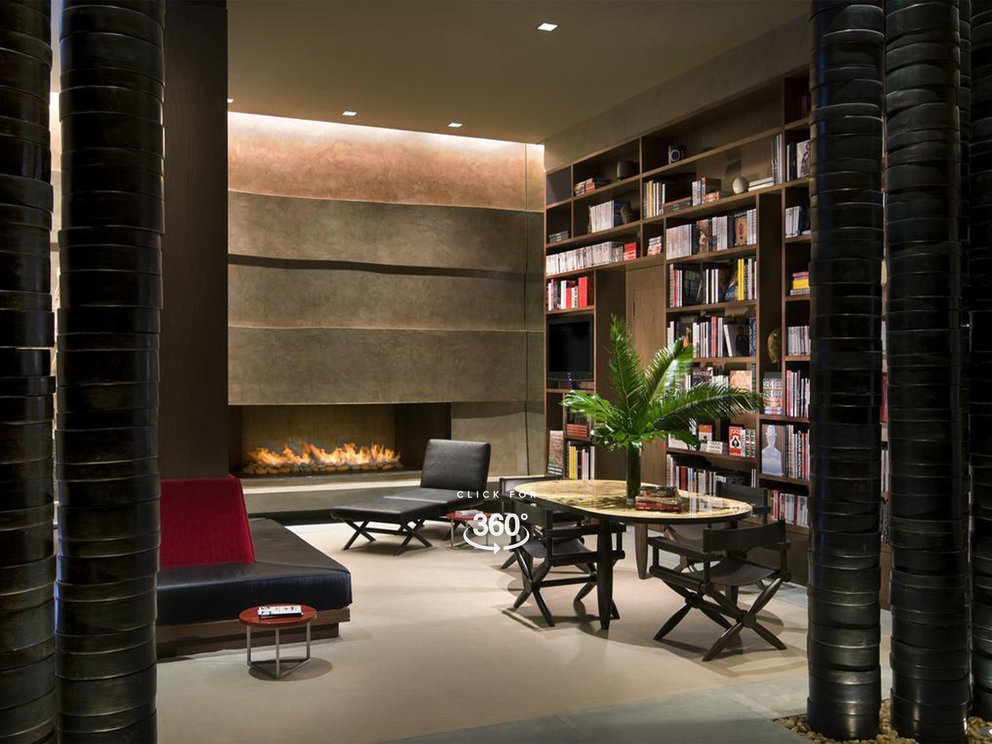 The Assouline Culture Lounge provides a luxurious space to relax next to a dramatic custom-designed graphite cement hearth.