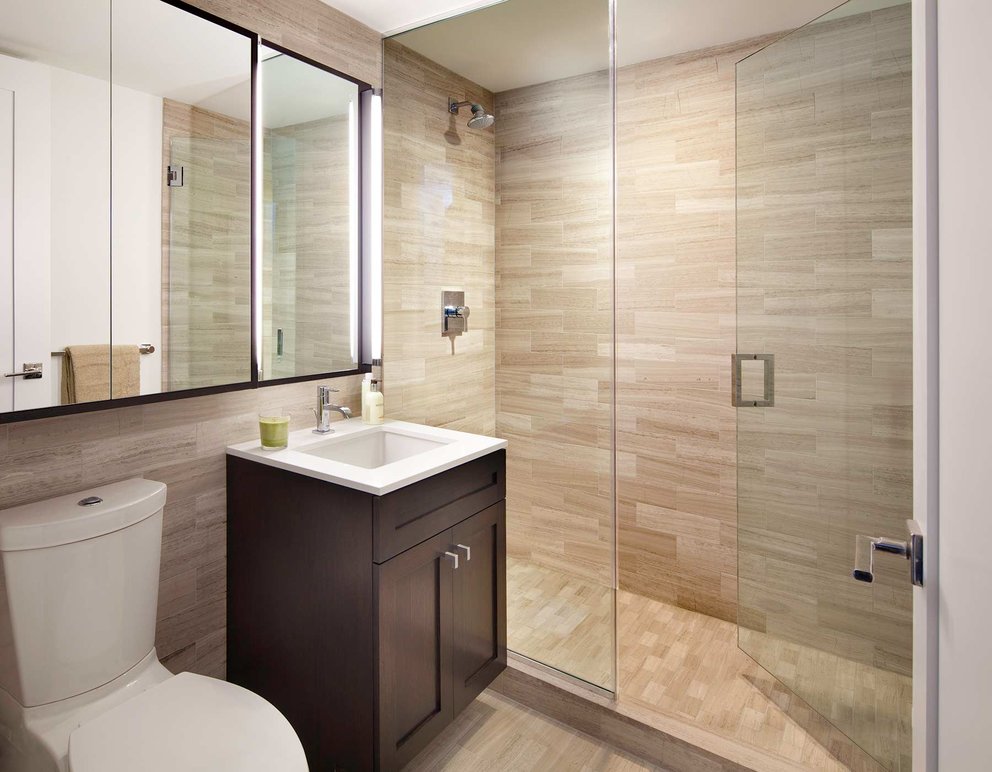 Luxurious bathrooms are clad in marble and include oversize medicine cabinets for easy storage.