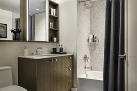 Custom bathrooms include imported Bianco Dolomite polished marble with marble mosaic feature walls