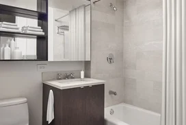 Sumptuous Botticino Fiorito Marble with ebonized walnut vanities.