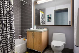 Luxurious tiled baths feature custom wood cabinetry and oversized custom-designed medicine cabinets.
