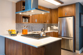 Gourmet kitchens include walnut cabinetry, Caesarstone countertops, and stainless steel KitchenAid® appliances.