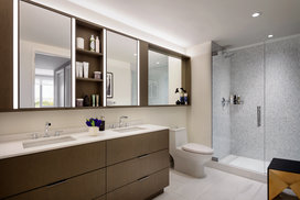 Custom bathrooms include imported Bianco Dolomite polished marble with marble mosaic feature walls
