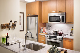 Walnut cabinetry, Italian marble countertops, and stainless steel appliances are just a few of the many ingredients that make these kitchens any chef's dream-come-true.