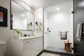 Classically tiled bathrooms feature oversized medicine cabinets.
