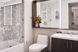 Inspired baths include a marble tub surround and glass enclosed shower, custom vanity and medicine cabinet.