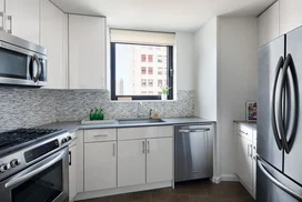 The gourmet kitchen at One Union Square South features Euro-style cabinetry and granite countertops.