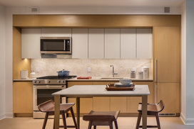 Italian designed and manufactured kitchens with custom oak cabinetry, natural Brazilian quartzite countertops and backsplash.