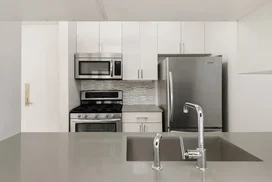 The gourmet kitchen at One Union Square South features Euro-style cabinetry and granite countertops.