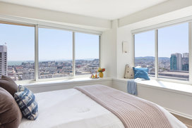 Large windows offer light-filled living with spectacular city views