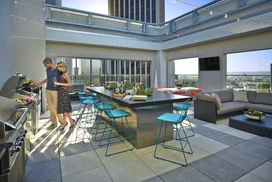 Rooftop terrace with dining tables and BBQ grills.