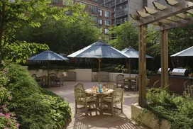The meticulously landscaped garden patio includes outdoor dining space with barbeques for residents.