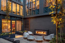 Landscaped courtyard with lounge area and fireplace