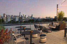 Rooftop Terrace with barbecue grills, fire pits and outdoor TVs set against views of the city skyline