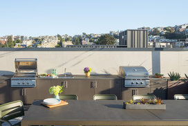 Rooftop Terrace with barbecue grills, fire pits and outdoor TVs set against views of the city skyline