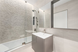 Bathrooms are equipped with heated floors, rain shower head system, and stainless steel plumbing. 