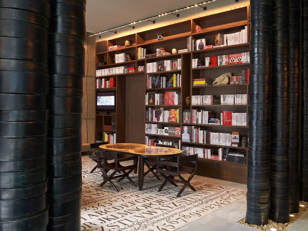 The Assouline Culture Lounge provides a luxurious space to relax next to a dramatic custom-designed graphite cement hearth.