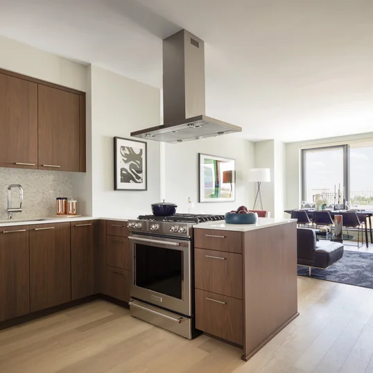 Custom walnut kitchen cabinetry, polished quartz countertops and Calacatta marble backsplash.