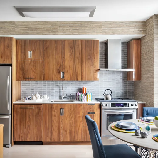 Gourmet kitchens include walnut cabinetry, Caesarstone countertops, and stainless steel KitchenAid® appliances.