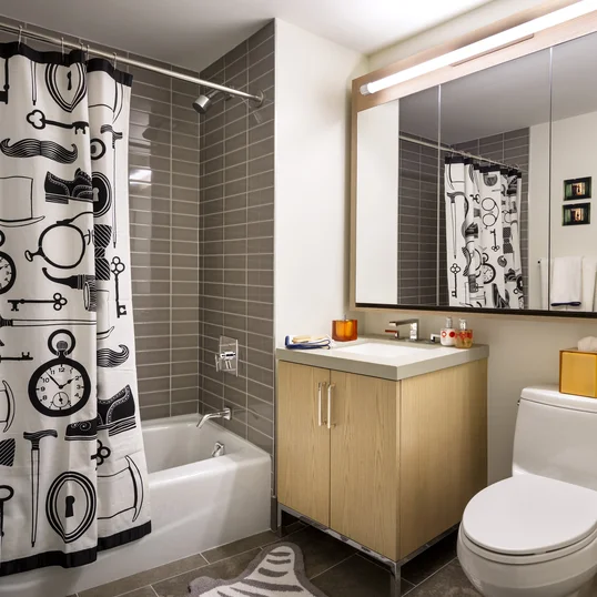 Luxurious tiled baths feature custom wood cabinetry and oversized custom-designed medicine cabinets.