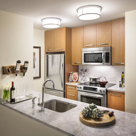 Walnut cabinetry, Italian marble countertops, and stainless steel appliances are just a few of the many ingredients that make these kitchens any chef's dream-come-true.