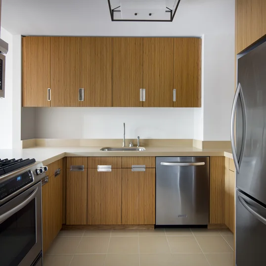 Superb kitchen finishes include quartzite stone countertops, bamboo cabinetry and stainless steel appliances.