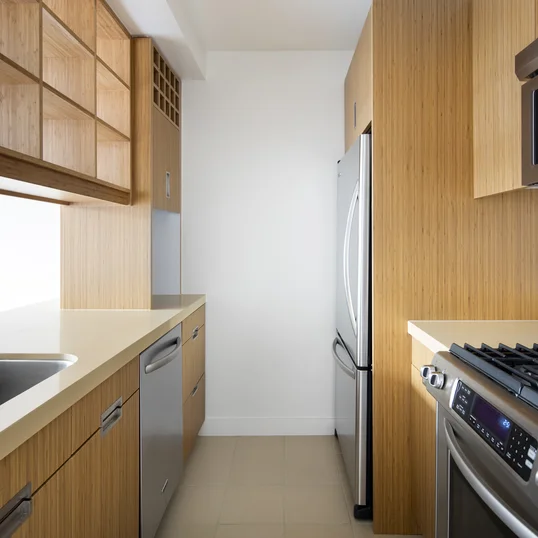 Superb kitchen finishes include quartzite stone countertops, bamboo cabinetry and stainless steel appliances.