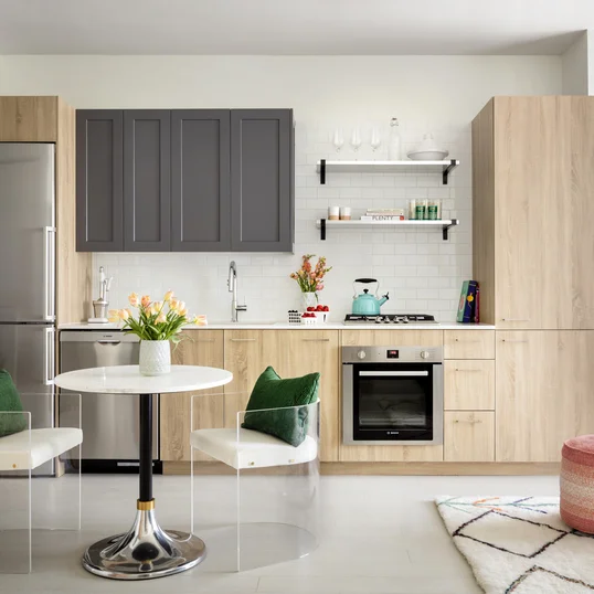Modern kitchens including Bosch appliances, refined subway tile backsplash, quartz kitchen counter-tops, stainless steel shelving and stainless steel single bowl sink.