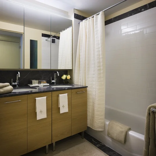 The designer baths at Riverwalk Crossing feature white ceramic tiled bathrooms with Grigio Alfoni marble vanity tops and accents.