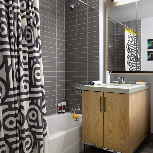 Luxurious tiled baths feature custom wood cabinetry and oversized custom-designed medicine cabinets.