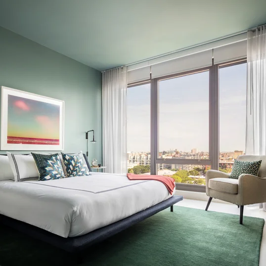 Spacious bedrooms include floor-to-ceiling windows.