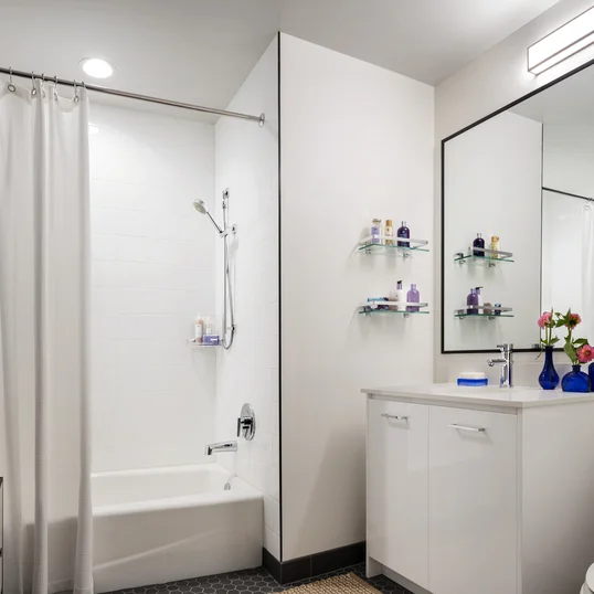 Classically tiled bathrooms feature oversized medicine cabinets. 