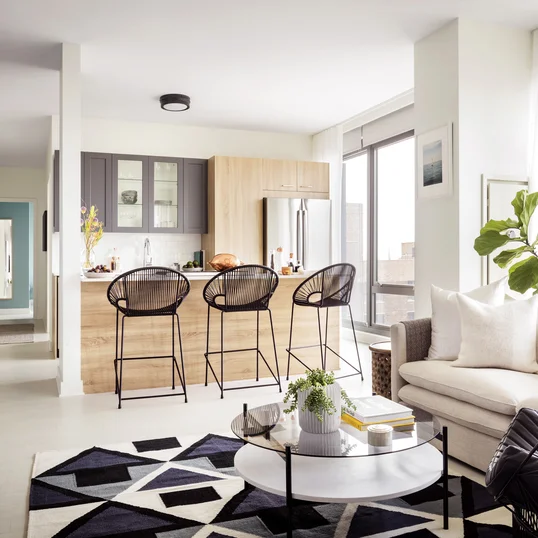 Modern kitchens include Bosch appliances, refined subway tile backsplash, quartz  countertops, stainless steel shelving, and stainless steel single bowl sink.