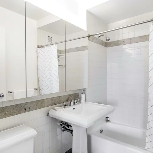 Classic marble bathrooms include charming pedestal sinks. 
