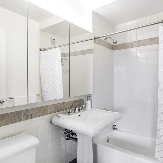 Classic marble bathrooms include charming pedestal sinks. 