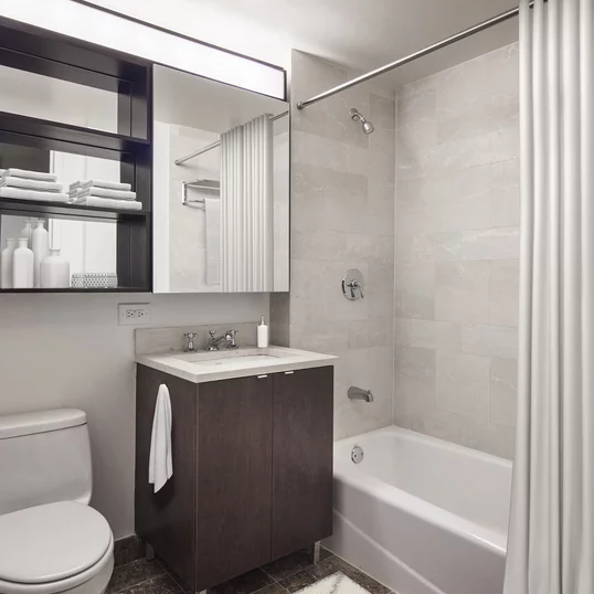 Sumptuous Botticino Fiorito Marble with ebonized walnut vanities.