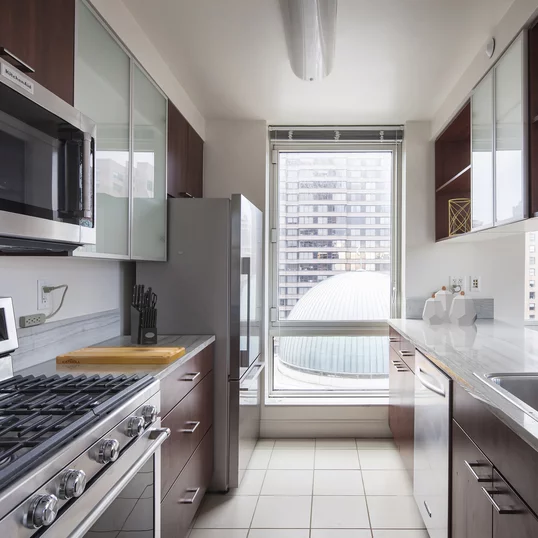 Gourmet stone kitchens feature stainless steel appliances, Euro-style walnut cabinetry, porcelain tile floors and glass accents.
