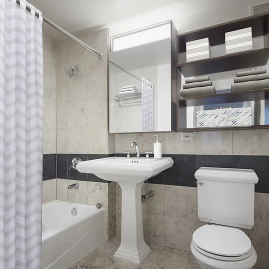 Classically decorated bathrooms with charming pedestal sinks.