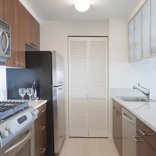 Gourmet stone kitchens feature stainless steel appliances, Euro-style walnut cabinetry, porcelain tile floors and glass accents.