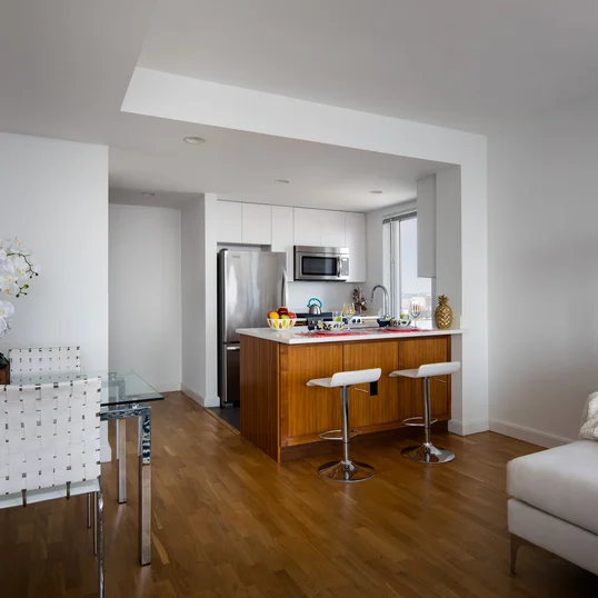 Light filled living rooms offering stunning views of New York City.