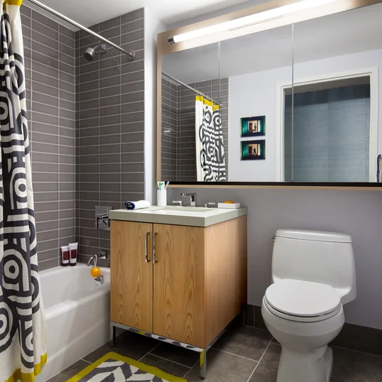 Luxurious tiled baths feature custom wood cabinetry and oversized custom-designed medicine cabinets.