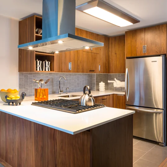 Gourmet kitchens include walnut cabinetry, Caesarstone countertops, and stainless steel KitchenAid® appliances.