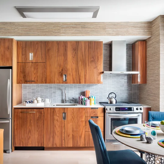 Gourmet kitchens include walnut cabinetry, Caesarstone countertops, and stainless steel KitchenAid® appliances.