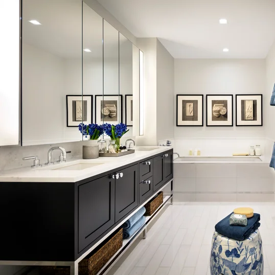 Custom walnut bathroom cabinetry with polished nickel hardware and imported Thassos polished marble countertop and floors, oversized marble showers and double vanities.