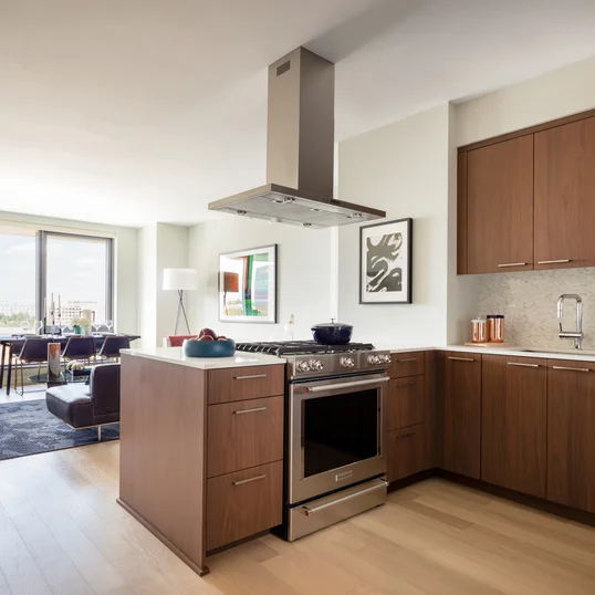 Masterfully appointed kitchens feature custom walnut kitchen cabinetry, polished quartz countertops, and Calacatta marble backsplash.