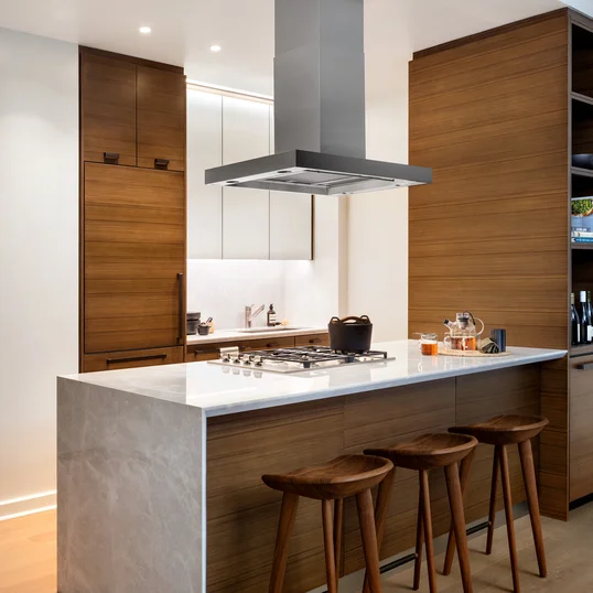 Custom kitchen cabinetry with matte black hardware, Turkish marble countertop and backsplash designed by Andre Kikoski Architect.